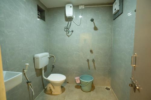 a bathroom with a toilet and a bath tub at Icon vista hotel in Tirupati