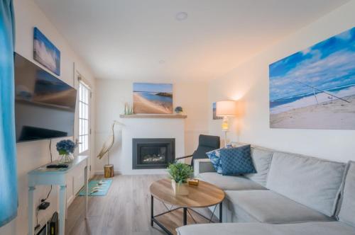 a living room with a couch and a fireplace at Sand, Sun Serenity: Cape Cod Escape in East Sandwich