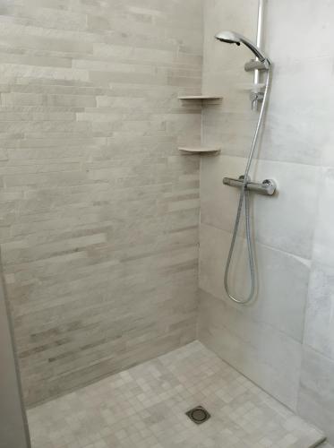 a bathroom with a shower with a glass door at Le Couvent in Lagardelle