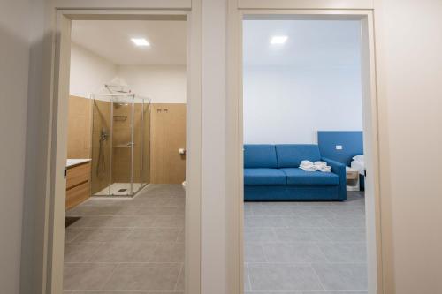a living room with a blue couch in a room at FEEL - Palazzo Ortelli in Bergamo