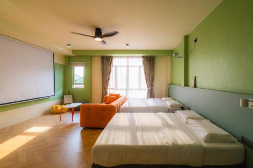 a room with two beds and a projection screen at Lot 78 in Malacca