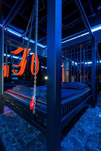 two beds in a room with blue lights at BDSM room Bydgoszcz z jacuzzi dużym tarasem i Balią zewnętrzną in Bydgoszcz