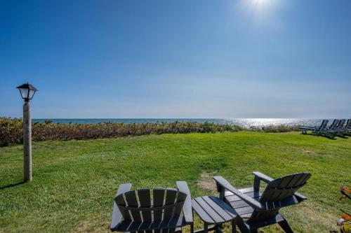 a group of chairs and a picnic table on the beach at The Shell Cottage - Where Beach Dreams Begin in South Yarmouth