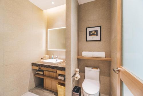 a bathroom with a toilet and a sink at Atour Hotel (Suzhou Xiangcheng) in Suzhou