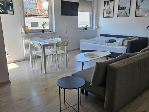 a living room with a couch and a table at Apartament Studio Centrum in Człuchów