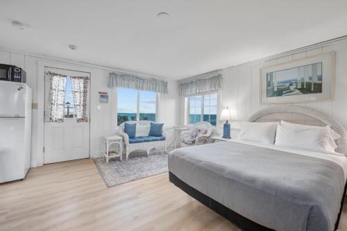 a bedroom with a bed and a living room at Oceans Edge: Drift, Dream, Repeat in South Yarmouth
