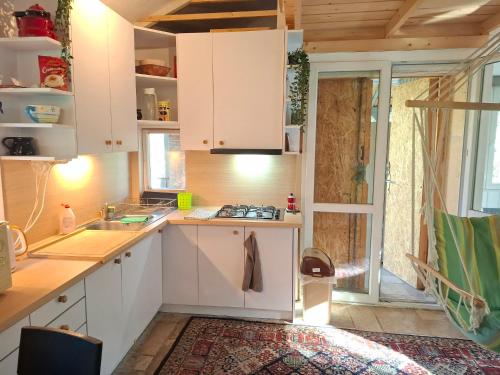 a kitchen with white cabinets and a sink at Gomba Kert in Nagymaros