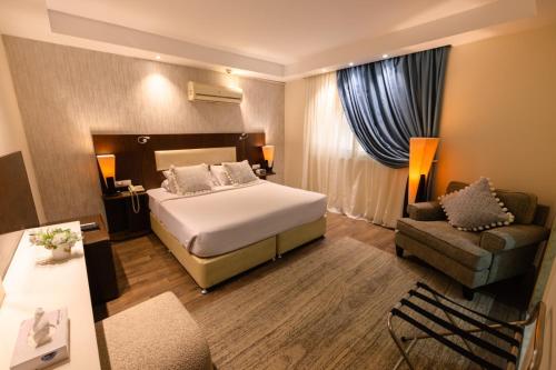 a hotel room with a bed and a couch at AlAshrafia Smart Residence in Cairo