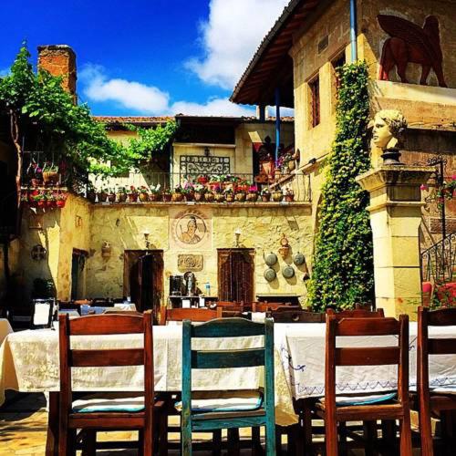 a table with two chairs and a table and a building at Sofa Hotel in Avanos