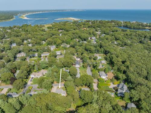 an aerial view of a park with trees and water at On Cape Time – Family Friendly Relaxing Escape in Osterville
