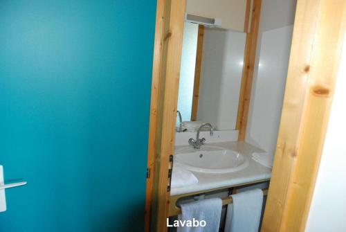 a bathroom with a sink and a mirror at Chalet Aster 1 in Blavignac