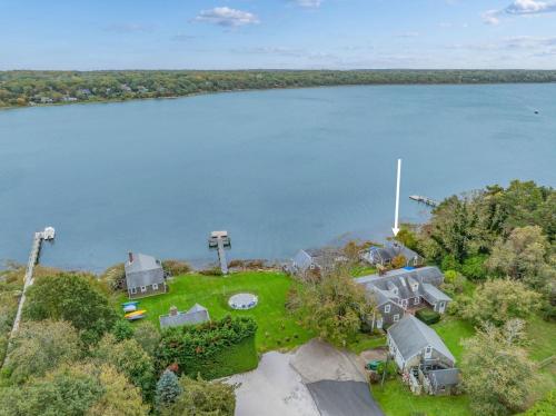 an aerial view of a house next to a body of water at Peaceful Covefront Cottage Retreat in Eastham in Eastham