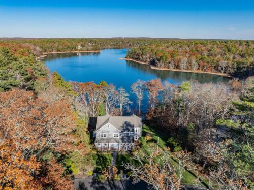 an aerial view of a house in the middle of a lake at Peaceful Cape Cod Escape with Pond Views Hot Tub in Sandwich