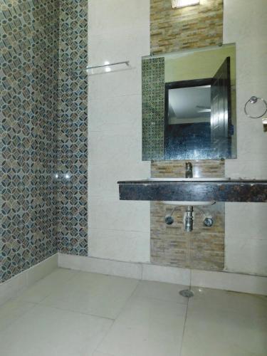a bathroom with a sink and a shower at Home By The Park in New Delhi
