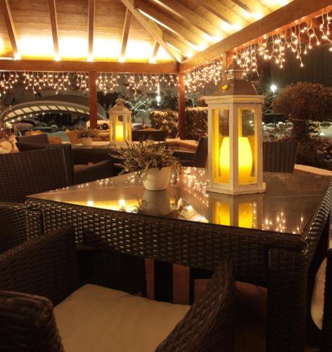 a patio with a table with lights and candles at Hotel La Bussola in Andalo