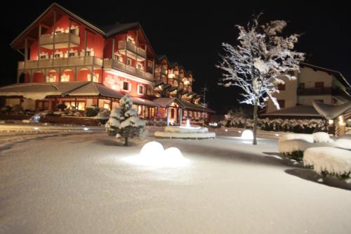 a large building with snow in front of it at Hotel La Bussola in Andalo