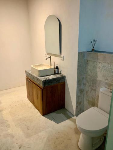 a bathroom with a sink and a toilet at Verdana Jungle Retreat Ubud in Ubud