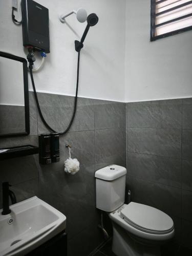 a bathroom with a white toilet and a sink at Homestay Idora PD in Port Dickson