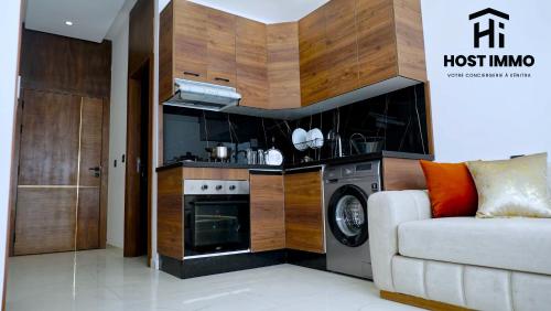 a living room with a stove and a couch at Apartment - Mehdia Beach in Kenitra