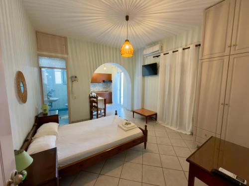 a bedroom with a large bed in a room at Natasa studios Kythera in Kythira