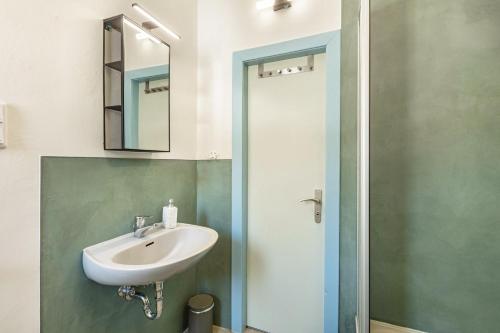 a bathroom with a sink and a shower at Ferienwohnung am Bertenberg -Keßler in Diemelsee