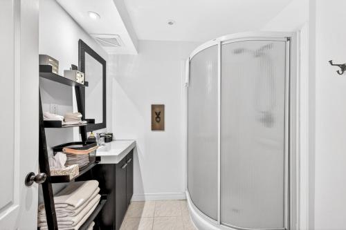 a bathroom with a shower and a sink at Hameau 33-104 in Stoneham