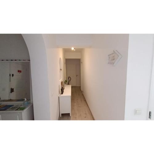 a kitchen with a table and a counter in a room at Vieiras House Quarto Solteiro in Barreiro