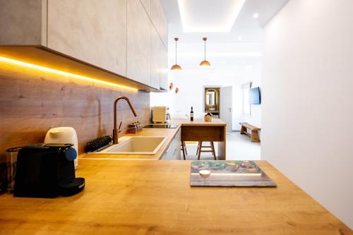 a kitchen with a table with a book on it at Caldera Jewel Santorini in Firostefani