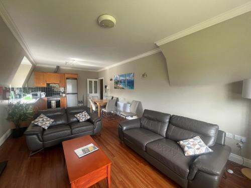 a living room with a couch and a table at River apartments, spacious 2 bedroom - muckross road killarney in Killarney
