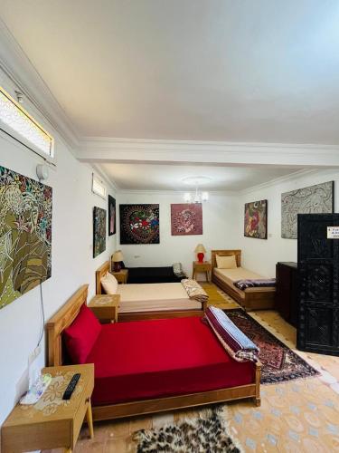 a living room with a large red couch in a room at Yamna home in Agadir