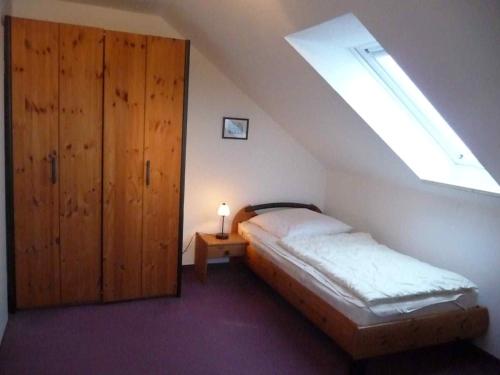 a bedroom with a bed and a skylight at NTBM36104-FeWo-Swalkennest in Neue Tiefe Fehmarn
