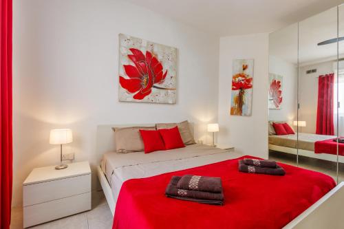 a bedroom with a red bed with a red blanket at Bright 3BR Penthouse with Pool & BBQ in Msida by QuickTrips in Misraħ Il-Barrieri