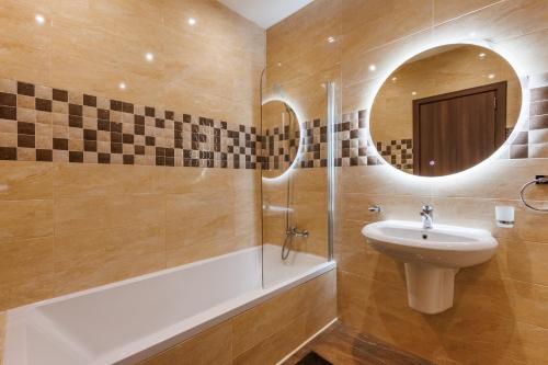 a bathroom with a sink and a mirror at Bright 3BR Penthouse with Pool & BBQ in Msida by QuickTrips in Misraħ Il-Barrieri