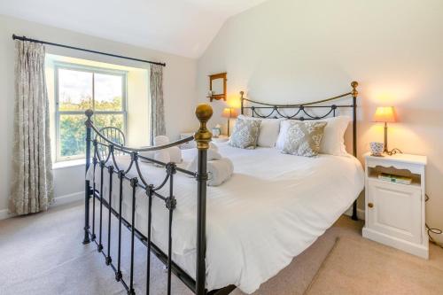 a bedroom with a large bed and a window at 4 Bed in St. Mawgan oc-p00610 in Saint Mawgan