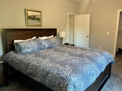 a bedroom with a bed with a blue comforter at Valhalla Resort Hotel in Helen