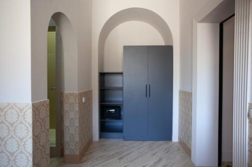 a hallway with a blue cabinet in a room at By Tau in Almaty