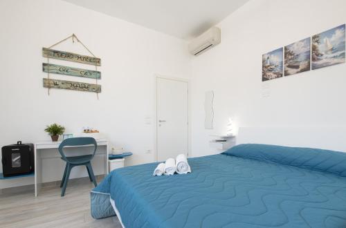 a bedroom with a blue bed and a blue chair at L'Ulivo bed and breakfast in Decima
