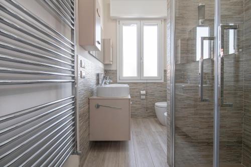 a bathroom with a sink and a toilet and a window at L'Ulivo bed and breakfast in Decima