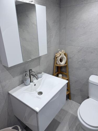 a bathroom with a white sink and a mirror at Little Gem -A Cycladic Aura- Serifos in Serifos Chora