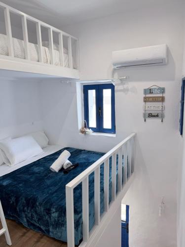 a white bedroom with a bed and a staircase at Little Gem -A Cycladic Aura- Serifos in Serifos Chora