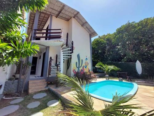 a house with a swimming pool in front of it at Pousada Toa Toa Em Pipa in Pipa