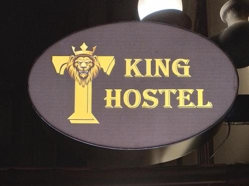 a sign for a king hospital with a lion and a cross at KING City Center Hostel in Baku