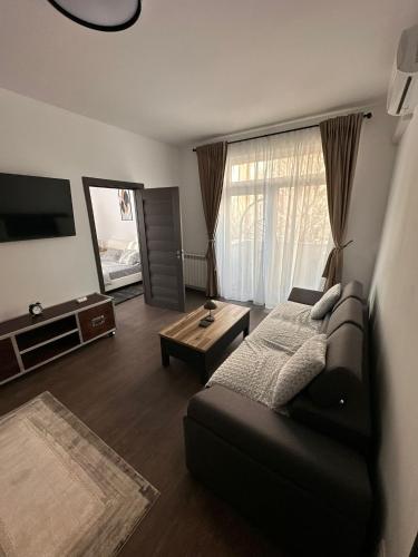 a living room with a couch and a table at Matei's Apartment by the Sea in Constanţa