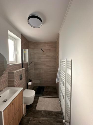 a bathroom with a toilet and a tub and a sink at Matei's Apartment by the Sea in Constanţa