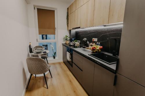 a kitchen with a sink and a counter top at Lumea Noir - Designer Apartment in Timișoara in Timişoara