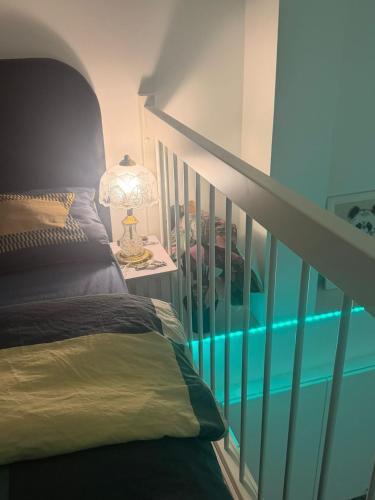 a room with a bed and a staircase with a lamp at Urban Pair Luxe Suites in Vantaa