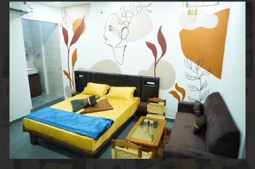 a bedroom with a bed and a couch at rajapalace in Zahirābād