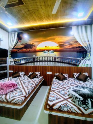 two beds on a boat with a painting on the wall at Hotel Manasvi in Khātu
