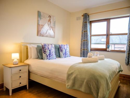a bedroom with a large bed and a window at Central Dingle Stay in Dingle