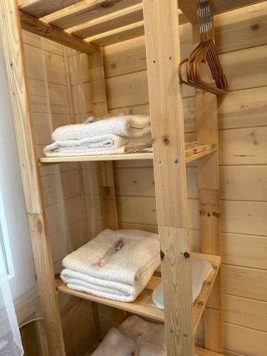 a wooden shelf with towels in a room at Bellissimo Garden Villa in Tsaghkadzor
